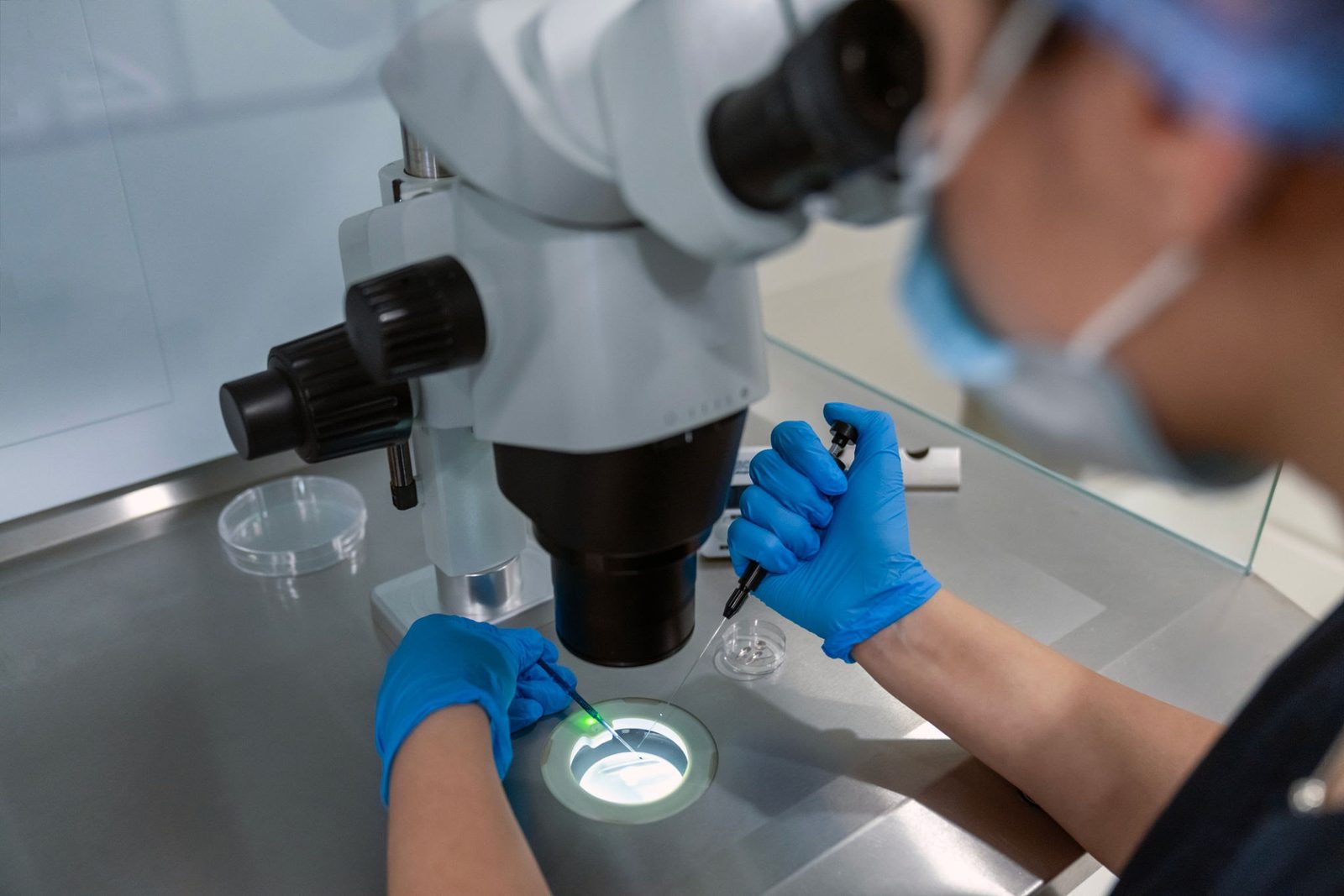Embryologist performing precision lab work with a frozen embryo sample